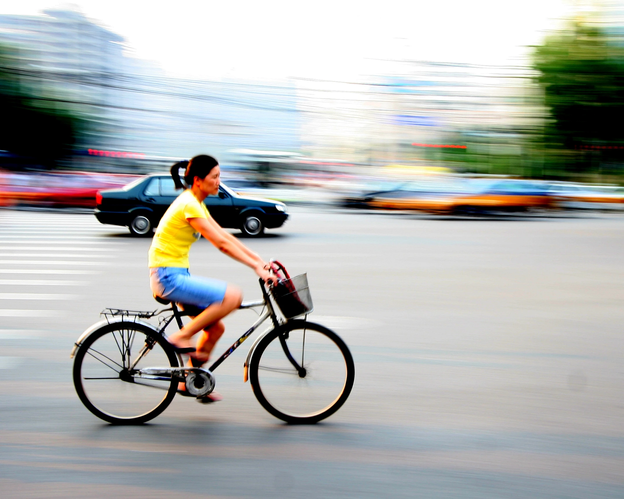 a woman wearing yellow is riding her bike