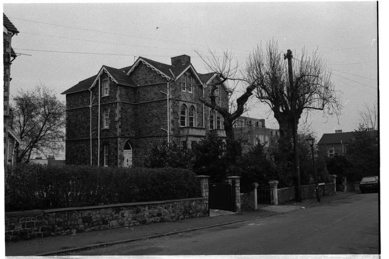 an old brick building sitting on the side of a road