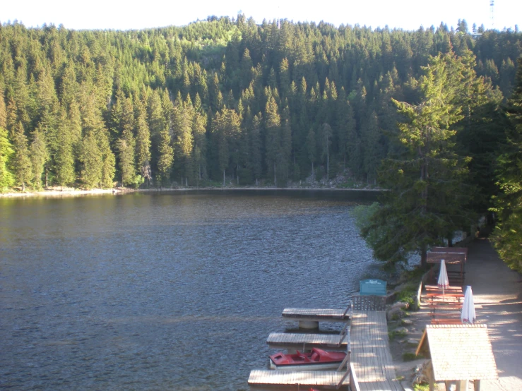 a long dock on a lake with boats