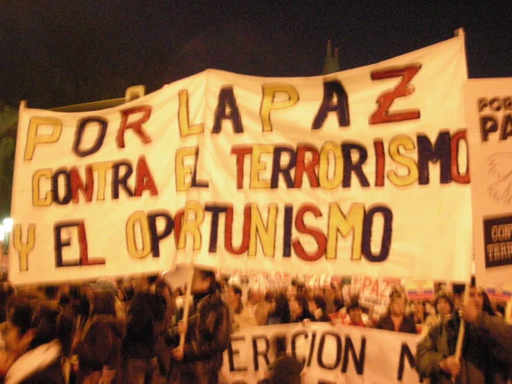 a group of people walking around holding banners