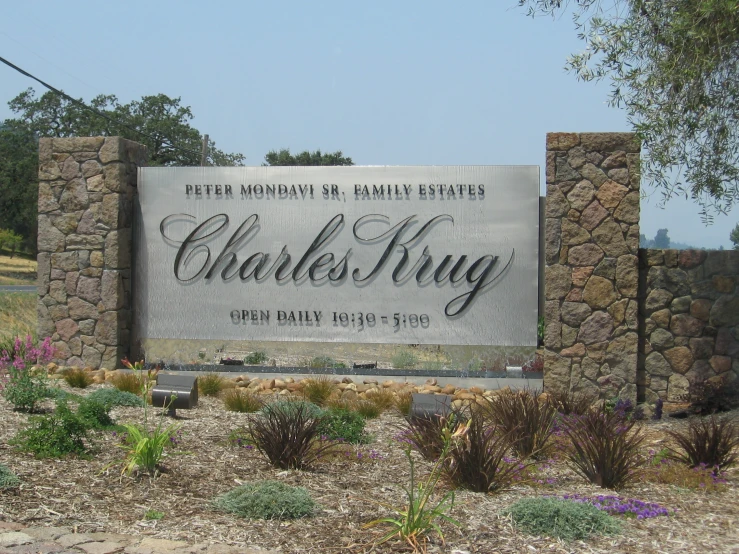 a stone and metal sign at the entrance to charles king