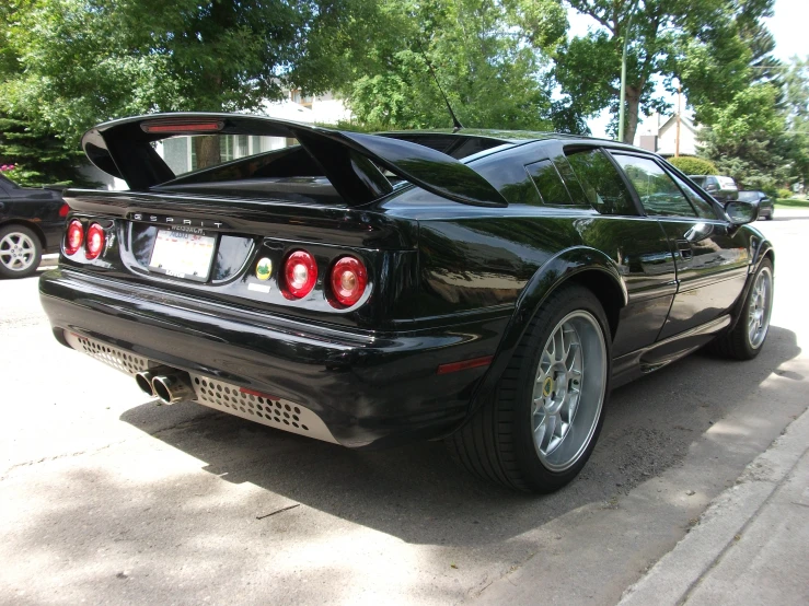 a black car is parked in the street