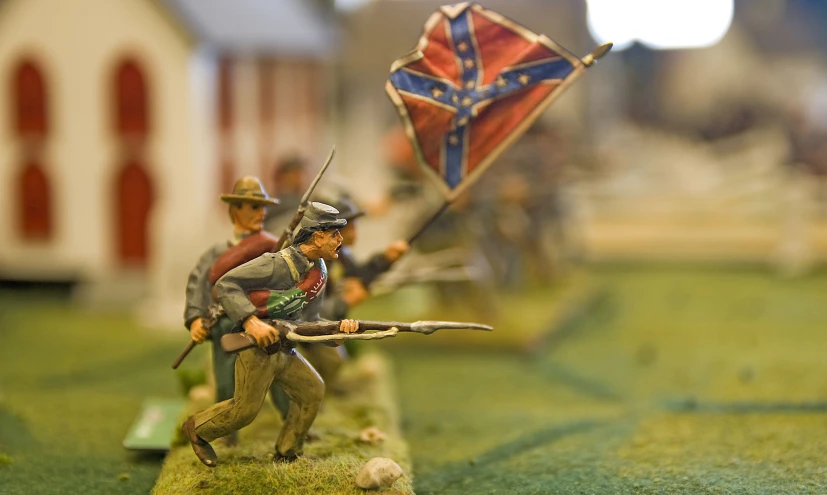 a couple of figurines that are holding some flags