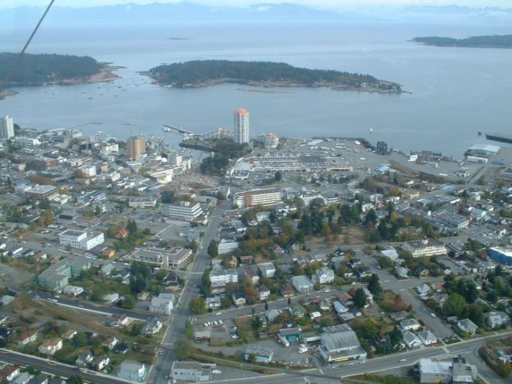 an aerial view of a city next to a lake