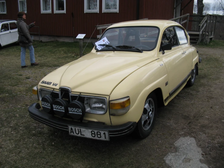 an old volvo is shown in a field with others