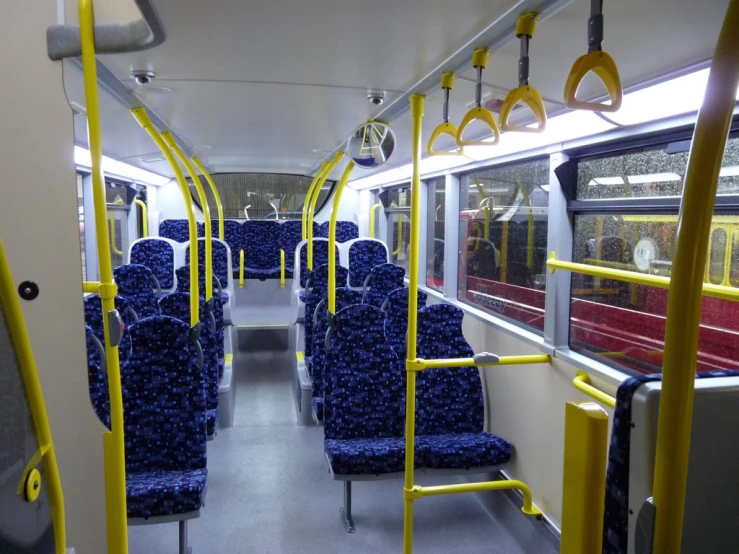 seats on the back of a bus, with yellow dividers