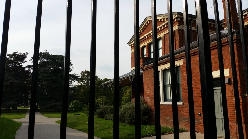 a building behind bars on the outside of it