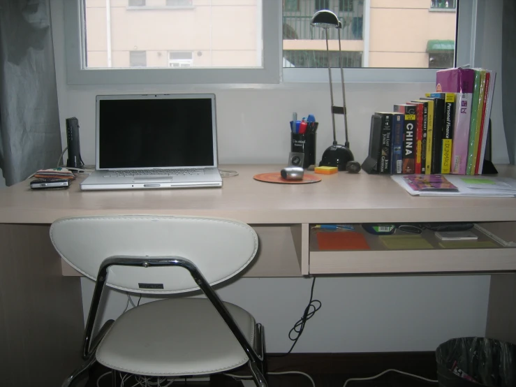 a laptop and a chair on top of a desk