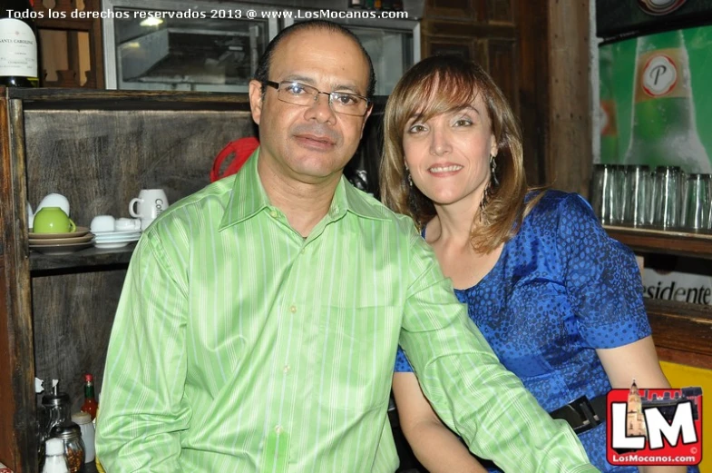 a man and woman posing for a po in a bar