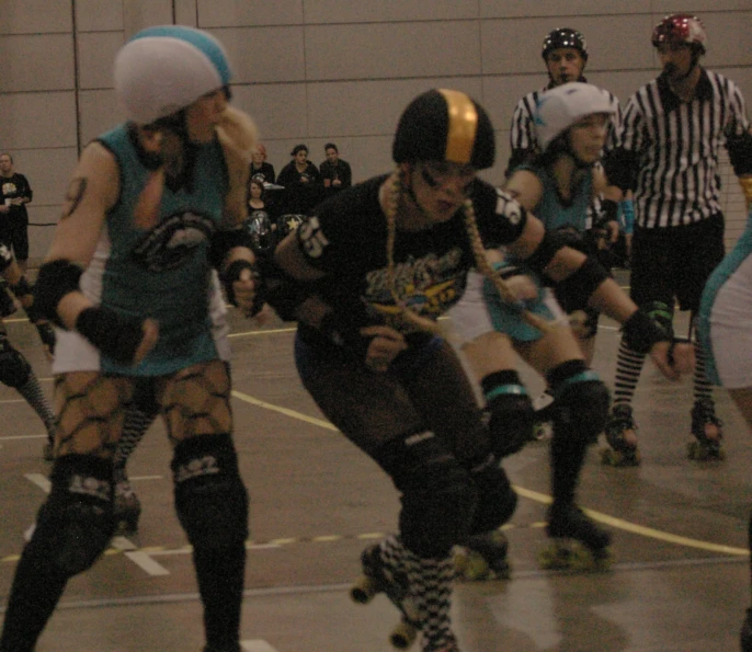 several girls on rollerblads in black helmets and white socks