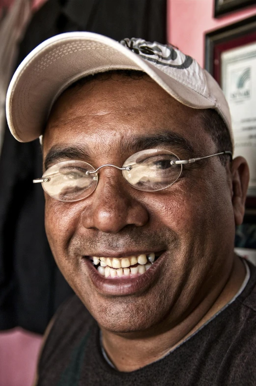 a close - up image of a man in glasses and a hat