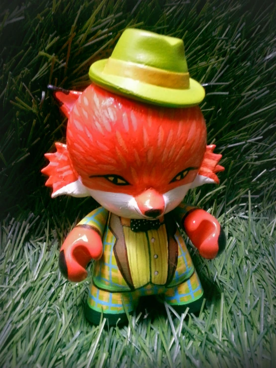 a little figurine wearing a colorful outfit and hat