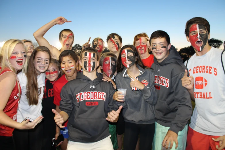 a group of people dressed in red and white cheer