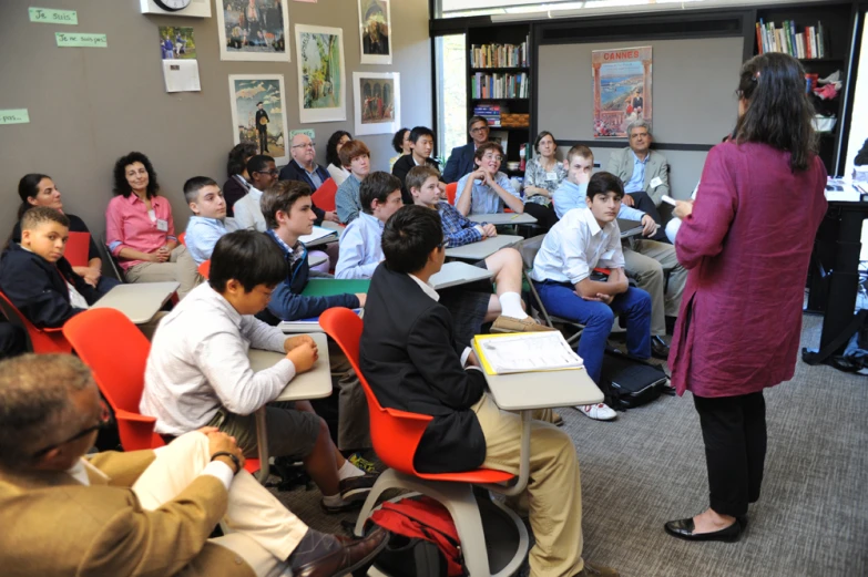 a group of people sitting and standing around a room