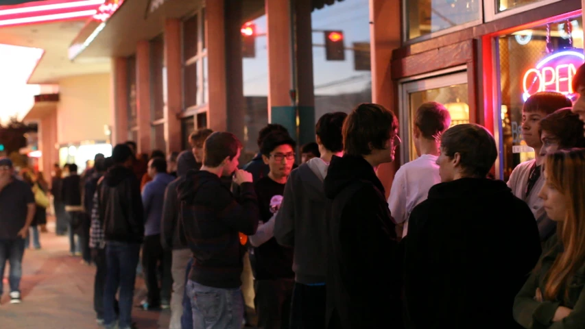 people are standing outside of a closed store