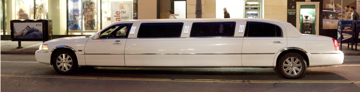 the limousine is parked on the side of the street