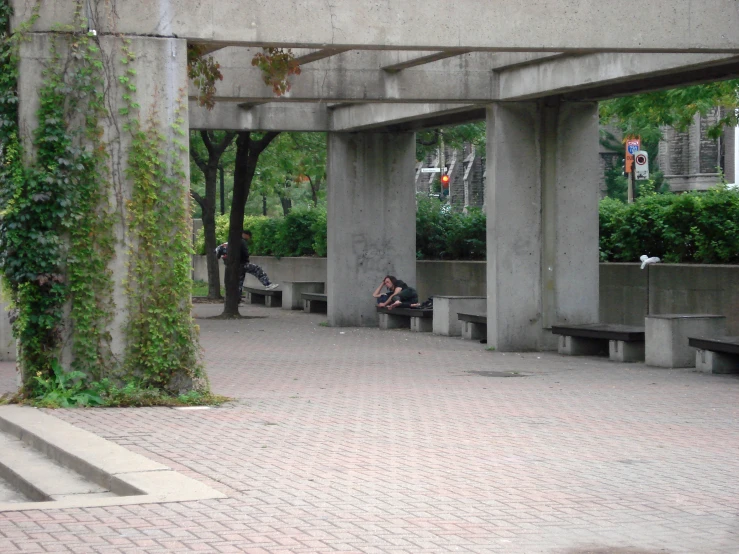 two people sitting on benches in a public area