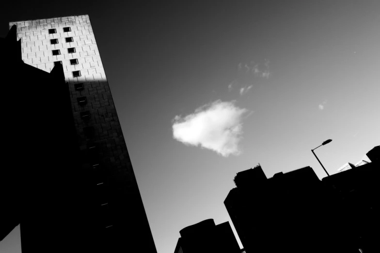 an object floats through the sky behind the buildings