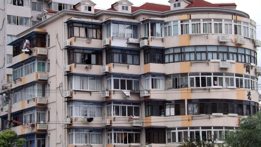 an old apartment building with large balconies on the top and second floor