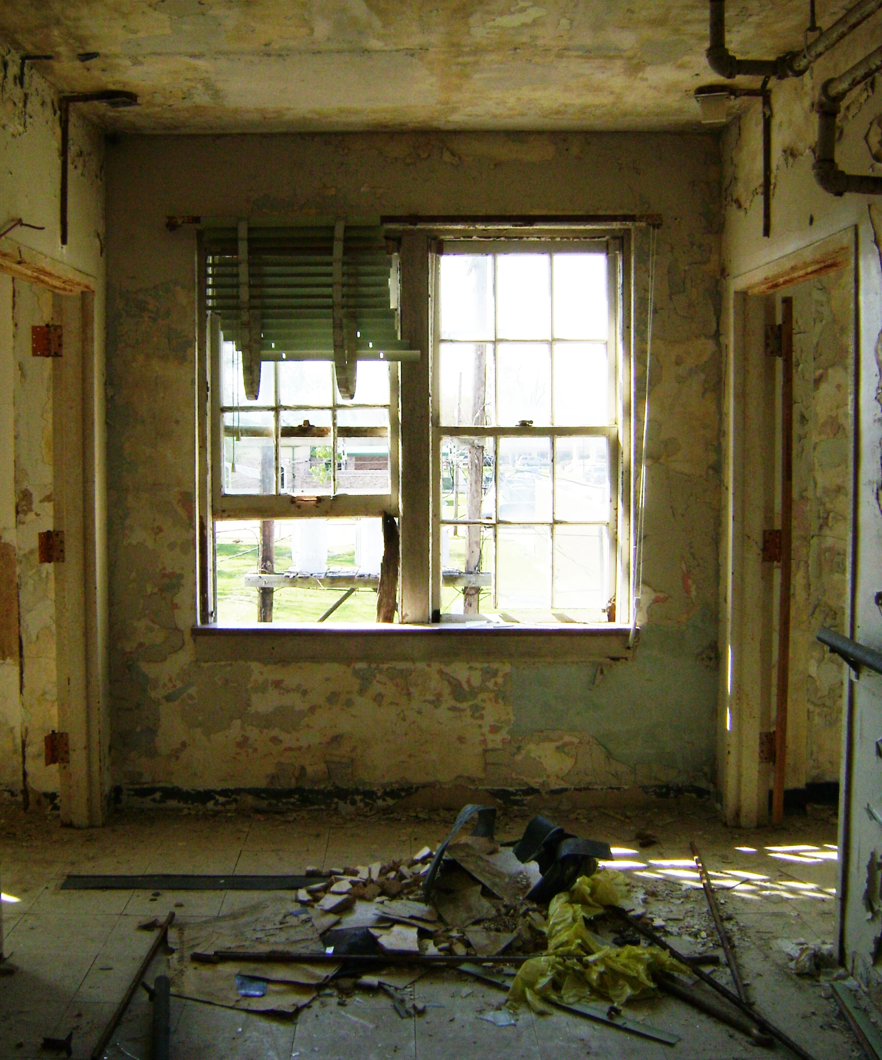 an unfinished room is seen with a broken ceiling