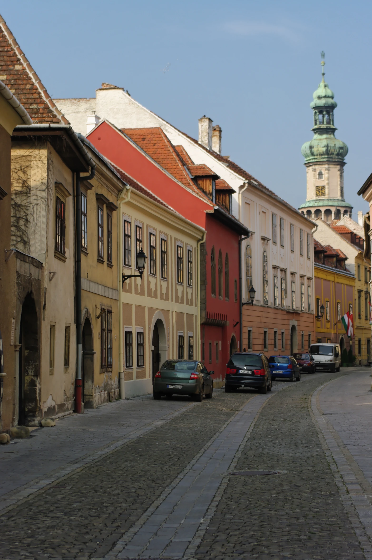 the cobblestone streets of a european town are lined with older houses