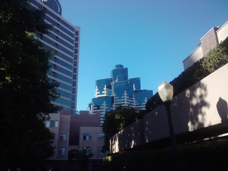 a view of some buildings in the distance with a man standing in front of it