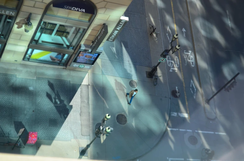 an overhead view of pedestrians walking down the sidewalk