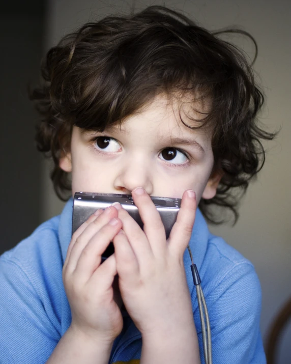 little  holding his chin against the mouth of his cell phone