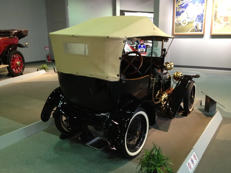 a vintage style car on display in a museum