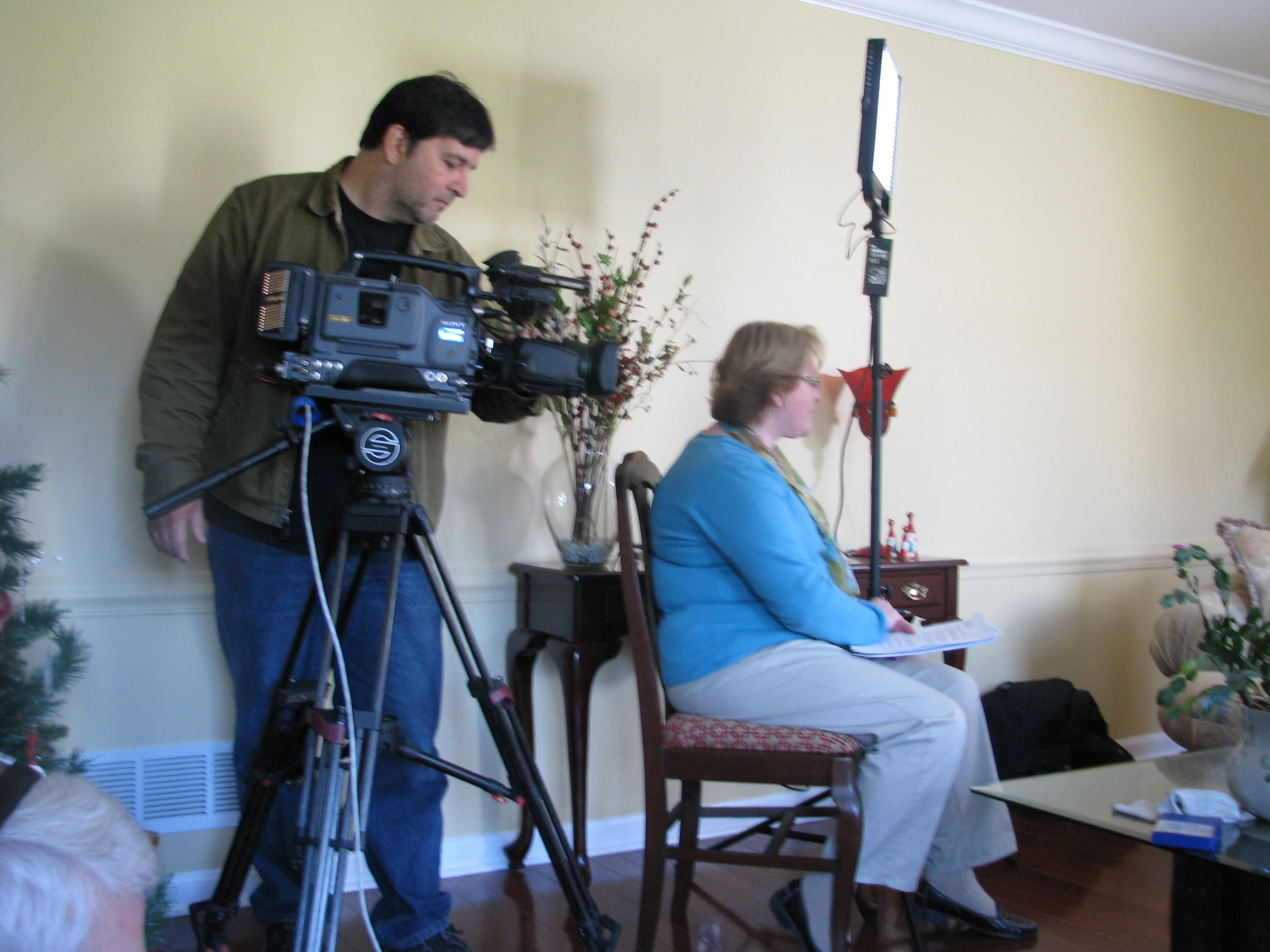 an image of camera man filming woman