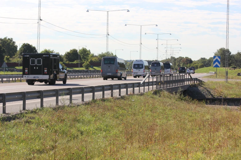 traffic travelling on the highway as two separate trucks go by