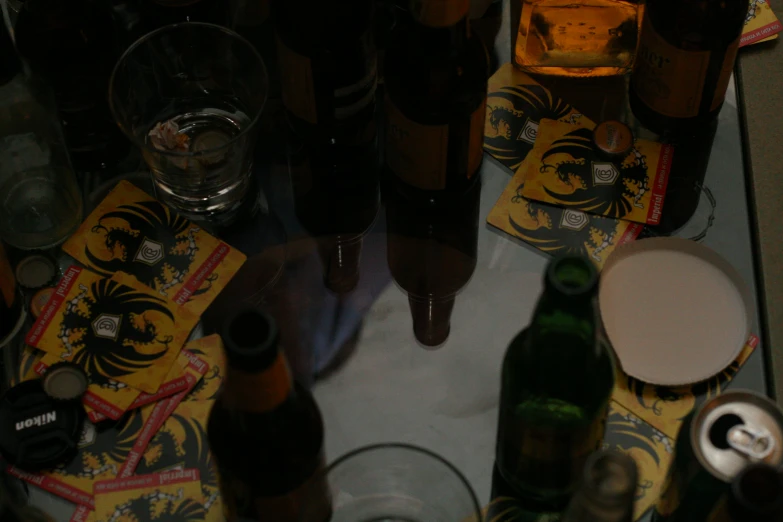 several bottle and glasses on a table with some napkins