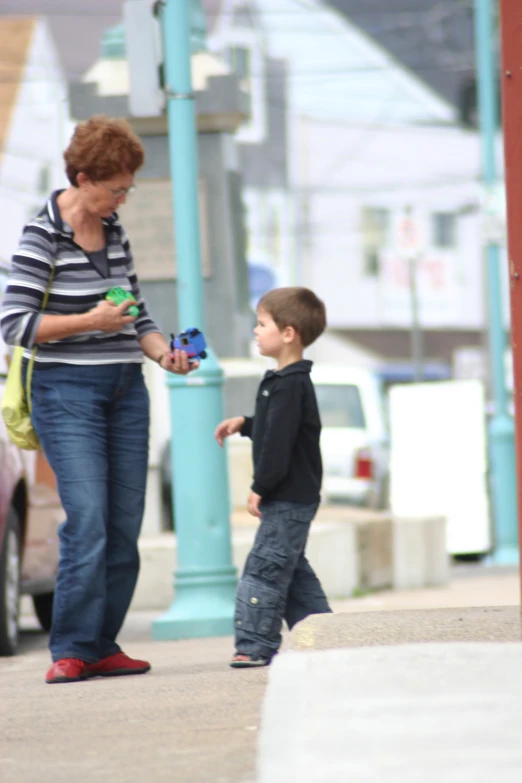 a woman talking to a  standing by the road