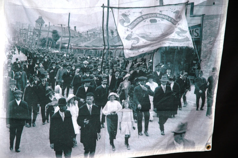 a vintage picture of a group of people standing in front of flags