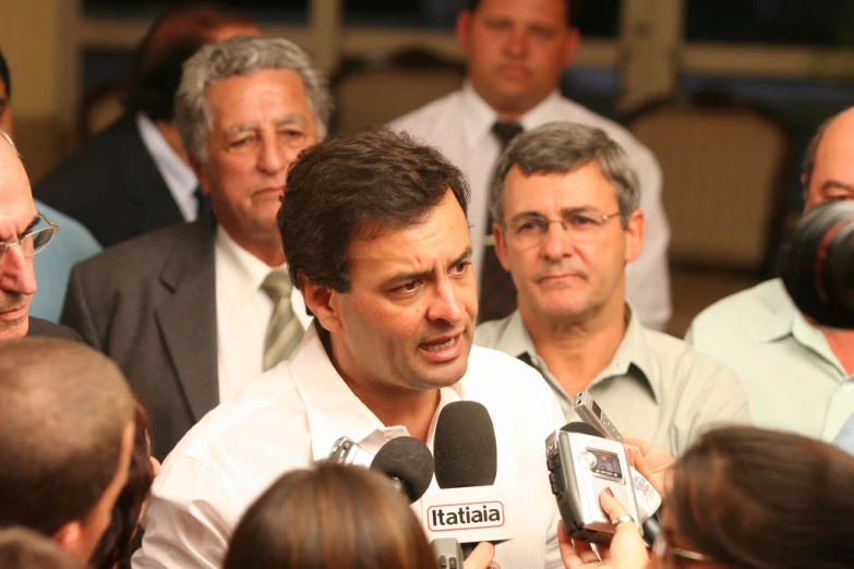 a man speaks in front of a group of people