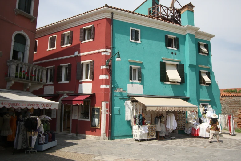 several storefronts on the corner of an old building