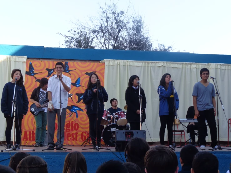 a group of people are standing on a stage