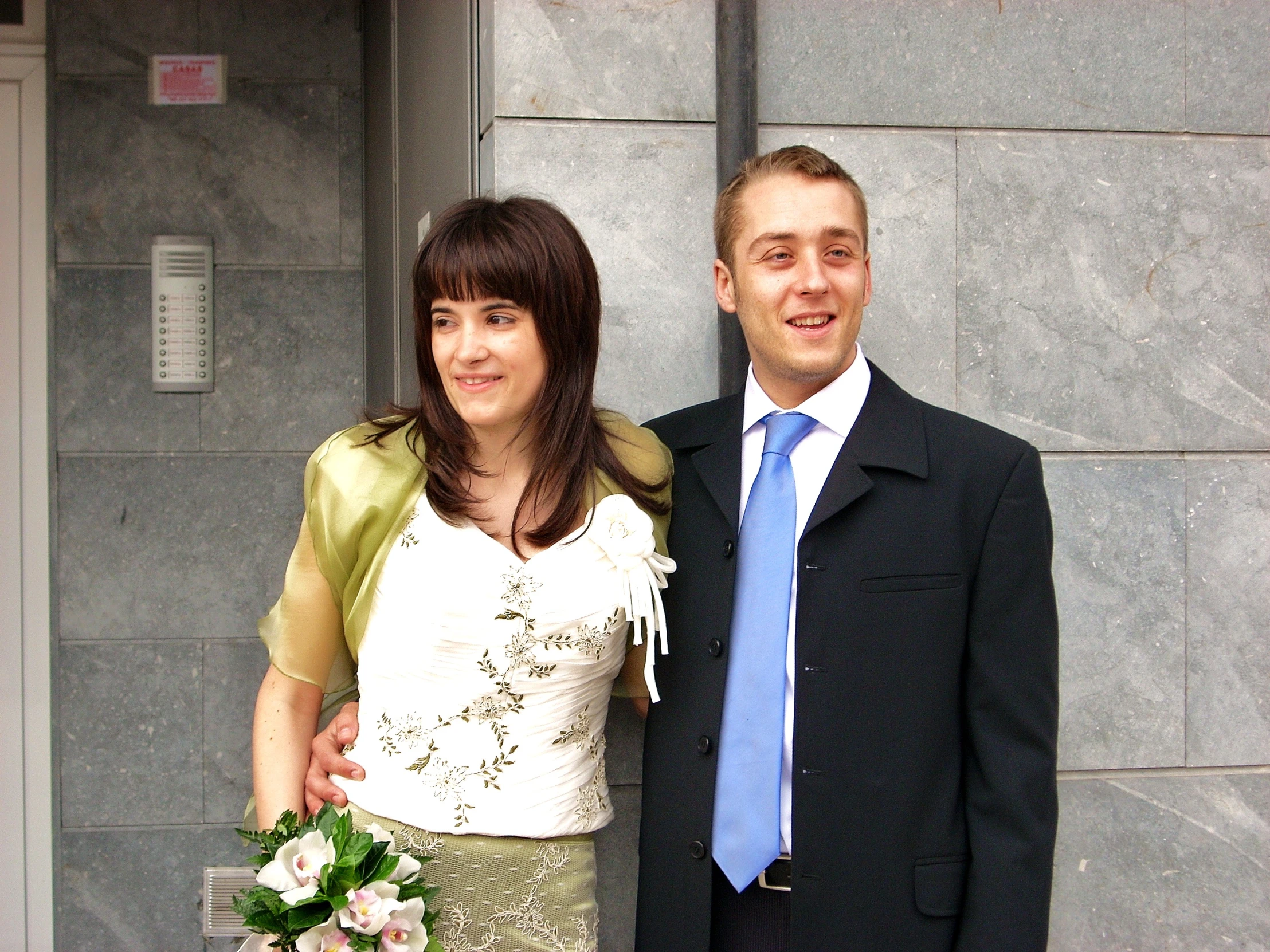 a young man standing next to a woman