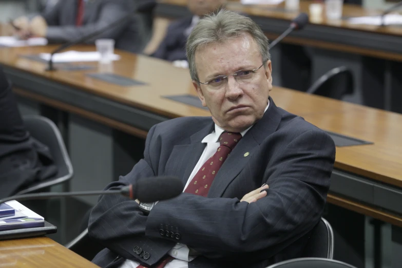 a man sitting in a room at a conference