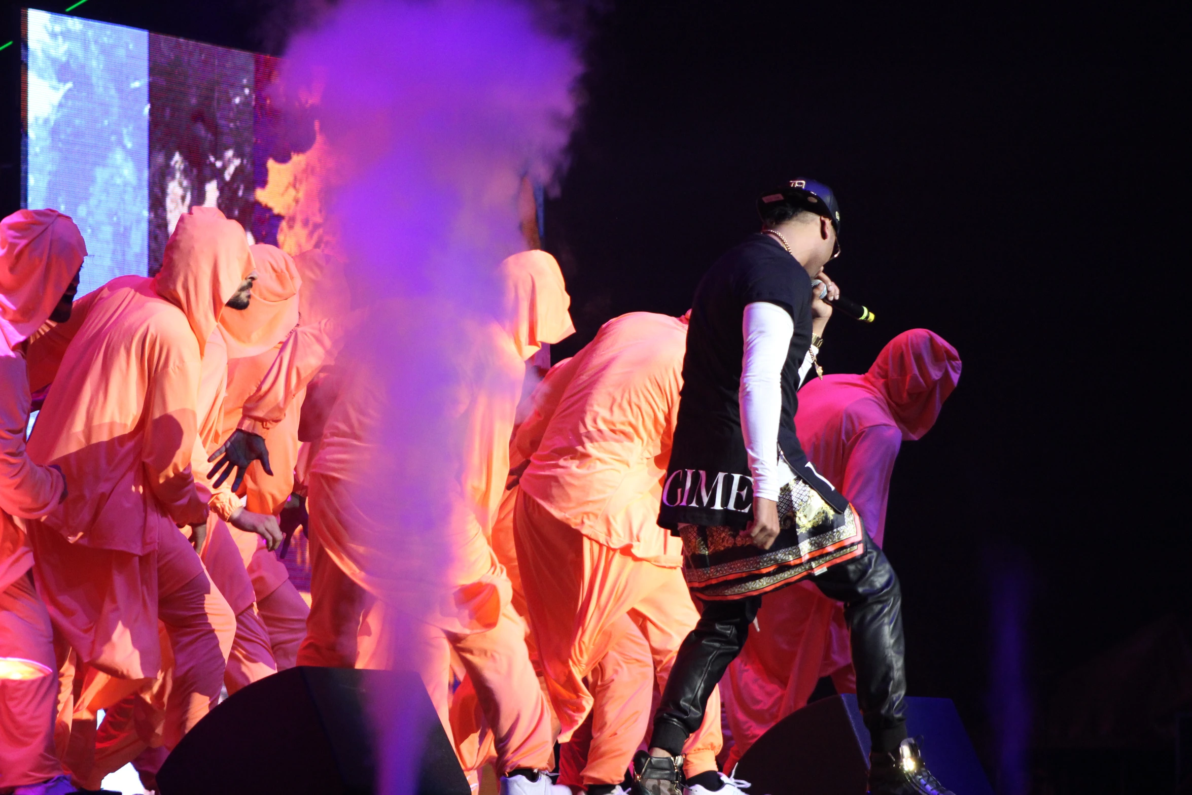 group of people dressed in orange robes on stage