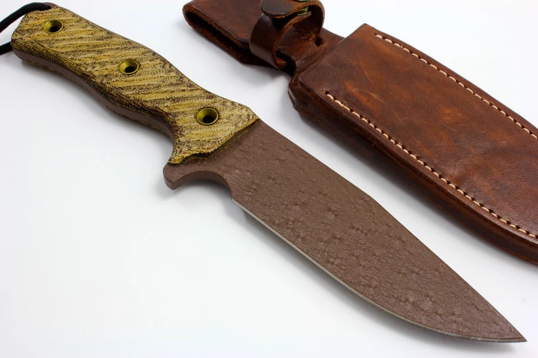 an open brown knife with yellow wood handles