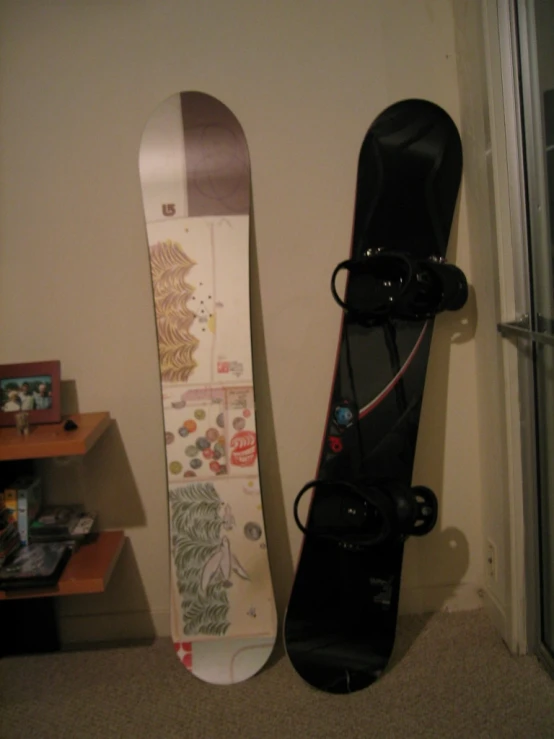 two snowboards next to each other on a carpeted floor