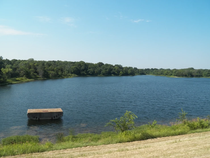 a small dock sits in the middle of a lake