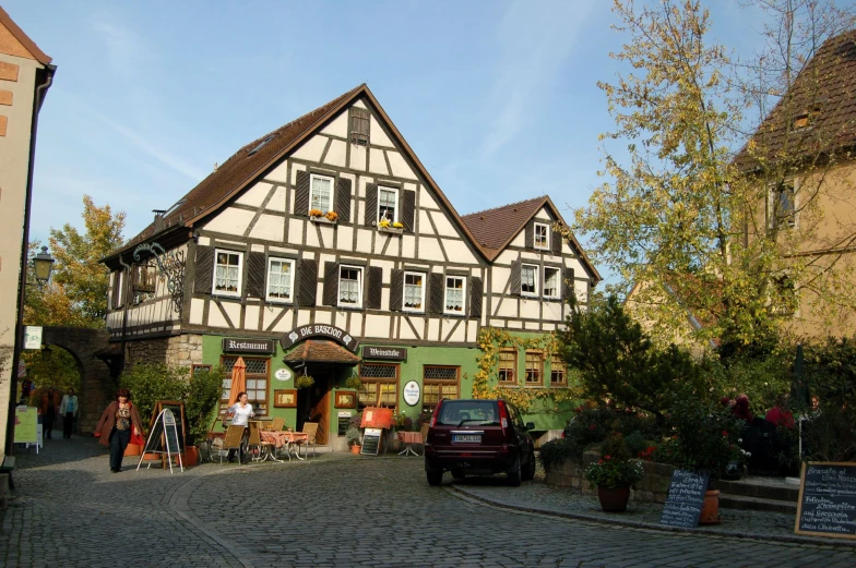 a tall building sitting on the side of a cobblestone road