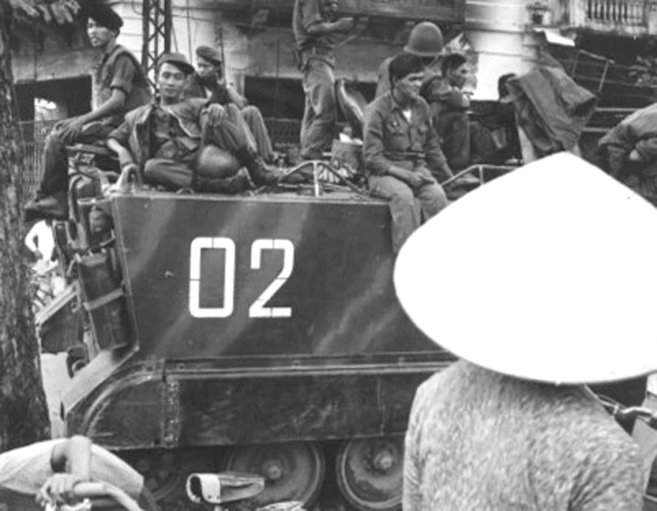 military men gathered in the back of an army truck