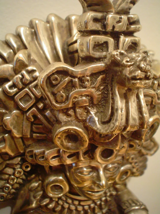 closeup image of various metal objects, including one of a statue's head