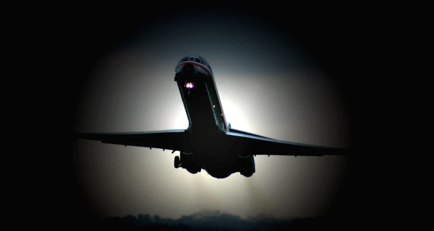 a jumbo jet airplane in front of the moon in the sky