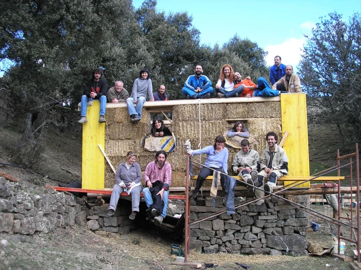 some people are sitting on top of a structure