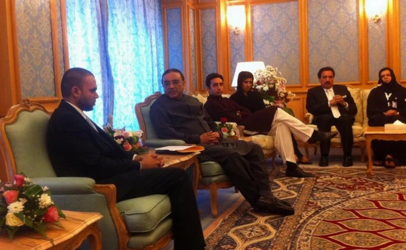 there are seven men seated together in formal attire