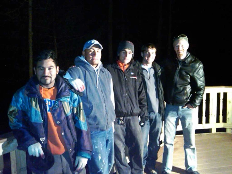 a group of men standing on top of a deck